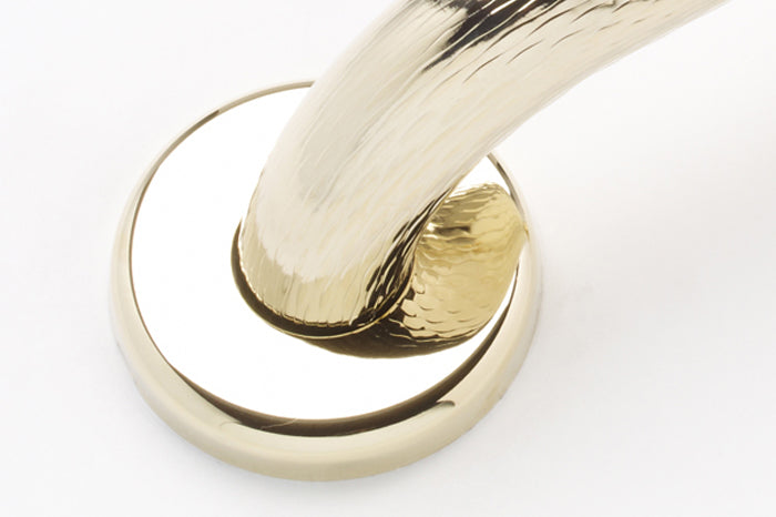 polished brass grab bars close up of flange